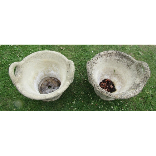 2093 - A pair of weathered cast composition stone garden planters in the form of wicker baskets with loop h... 