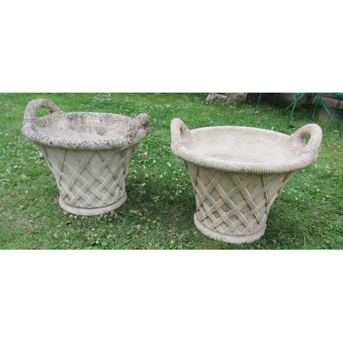 2093 - A pair of weathered cast composition stone garden planters in the form of wicker baskets with loop h... 