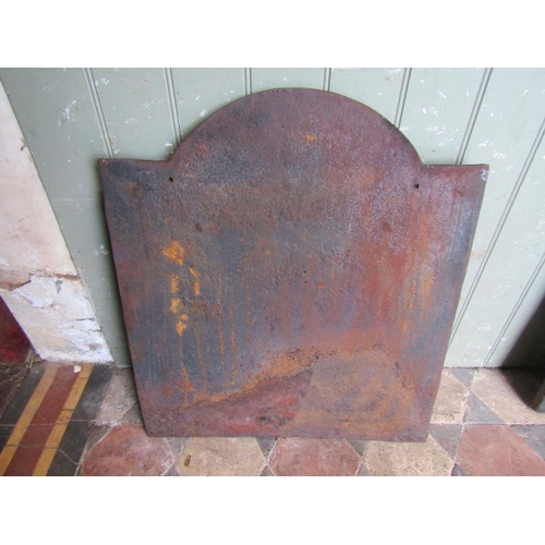 2094 - An old cast iron fire back with raised relief inverted anchor, crown, and further detail, 53cm wide ... 