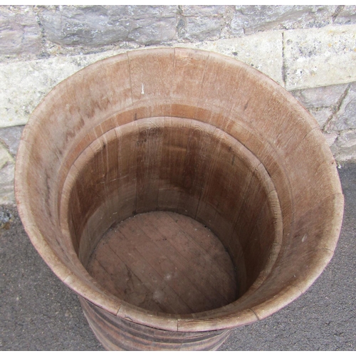 2109 - A large coopered oak and steel banded barrel/tub of tapered and flared form, approx 60cm diameter x ... 