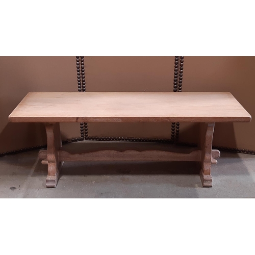 2120 - A low limed oak occasional table with rectangular top raised on shaped supports and sledge feet unit... 