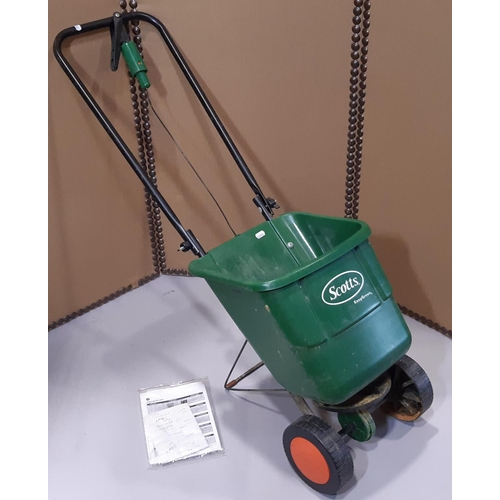 2130 - A Hozelock encased wall mounted hose reel together with a Scotts easy green rotary spreader model nu... 