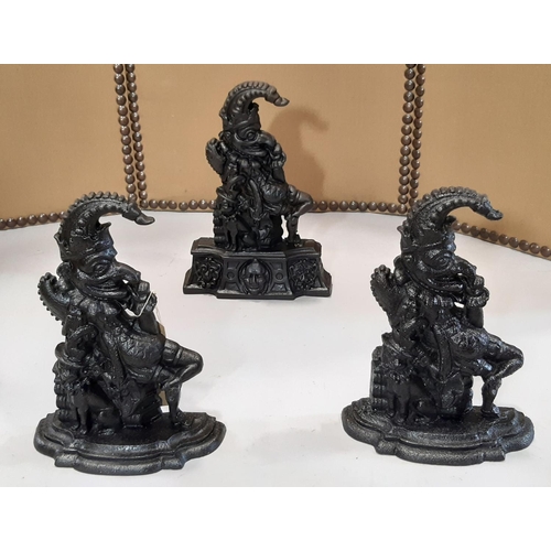 2151 - A matched pair of Mr Punch cast iron door porters with stepped shaped bases, 32 cm high, together wi... 