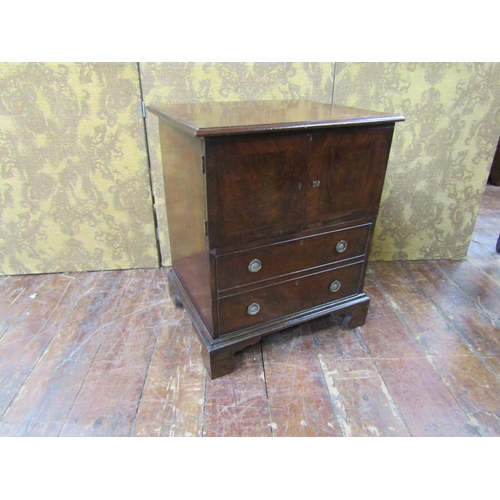 2599 - A Georgian mahogany side cupboard, the lower section enclosed by a full front disguised as two drawe... 