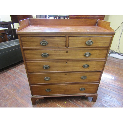 2601 - A Georgian mahogany chest of four long and two short graduated drawers set beneath a three quarter g... 