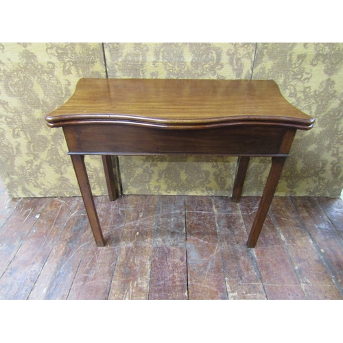 2608 - A Georgian mahogany fold over top tea table, the serpentine top raised on a rectangular base with sq... 