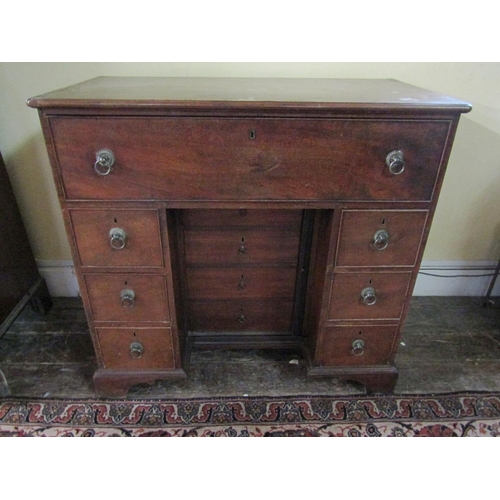 2610 - A Georgian mahogany secretaire chest, the secretaire with fitted drawers and central alcoves, the kn... 