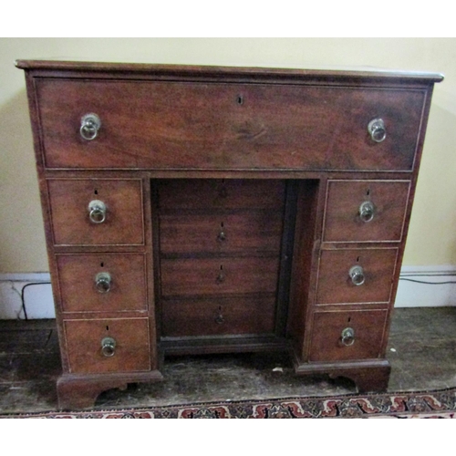 2610 - A Georgian mahogany secretaire chest, the secretaire with fitted drawers and central alcoves, the kn... 