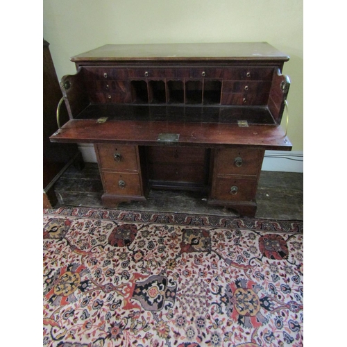 2610 - A Georgian mahogany secretaire chest, the secretaire with fitted drawers and central alcoves, the kn... 