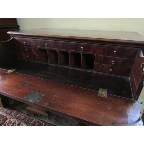 2610 - A Georgian mahogany secretaire chest, the secretaire with fitted drawers and central alcoves, the kn... 