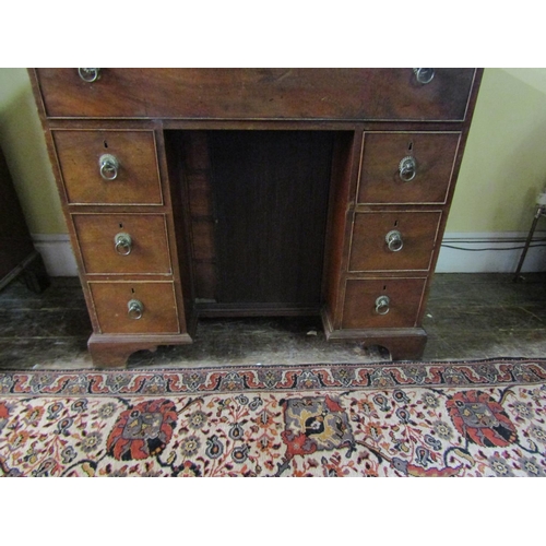 2610 - A Georgian mahogany secretaire chest, the secretaire with fitted drawers and central alcoves, the kn... 