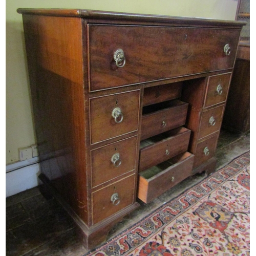 2610 - A Georgian mahogany secretaire chest, the secretaire with fitted drawers and central alcoves, the kn... 