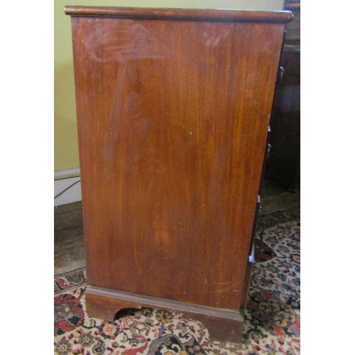 2610 - A Georgian mahogany secretaire chest, the secretaire with fitted drawers and central alcoves, the kn... 