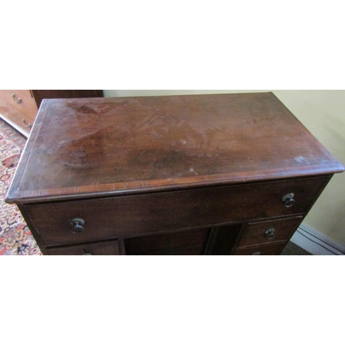 2610 - A Georgian mahogany secretaire chest, the secretaire with fitted drawers and central alcoves, the kn... 