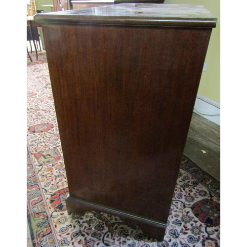 2610 - A Georgian mahogany secretaire chest, the secretaire with fitted drawers and central alcoves, the kn... 