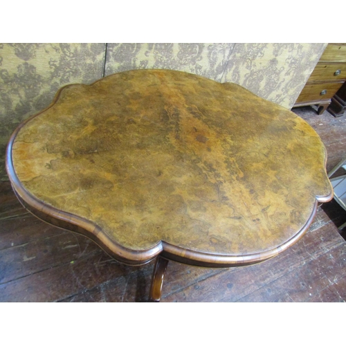 2622 - A Victorian walnut and figured walnut loo table with quarter veneered top, shaped outline and raised... 