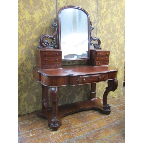 2624 - A Victorian mahogany Duchess dressing table with arched mirror, carved and shaped supports open an o... 