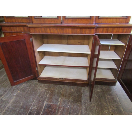 2628 - A Victorian mahogany four door breakfront library bookcase, the lower section enclosed by arched and... 