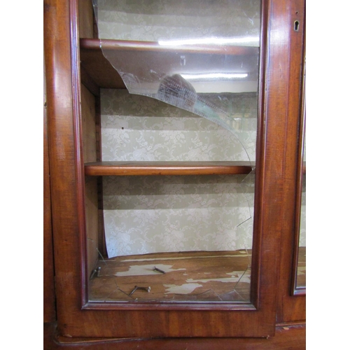 2628 - A Victorian mahogany four door breakfront library bookcase, the lower section enclosed by arched and... 