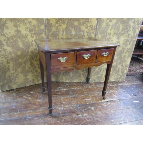 2629 - A Georgian low boy, mixed woods including fruitwood enclosing three frieze drawers on square taper l... 