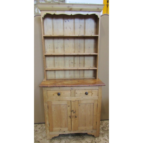 2119 - A stripped pine cottage kitchen dresser, the base enclosed by a pair of rectangular panelled doors b... 