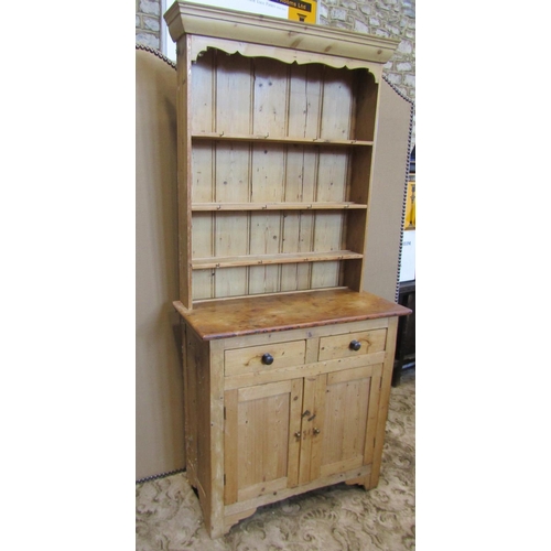 2119 - A stripped pine cottage kitchen dresser, the base enclosed by a pair of rectangular panelled doors b... 