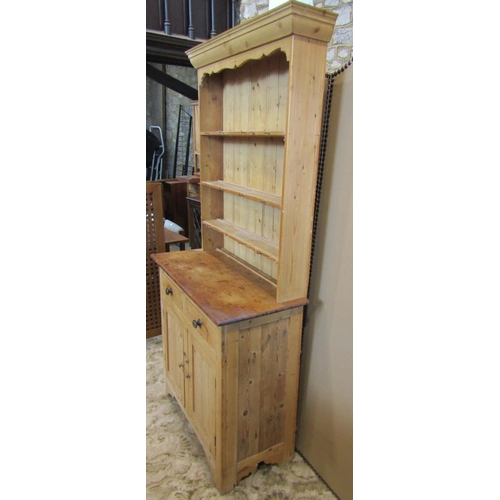 2119 - A stripped pine cottage kitchen dresser, the base enclosed by a pair of rectangular panelled doors b... 