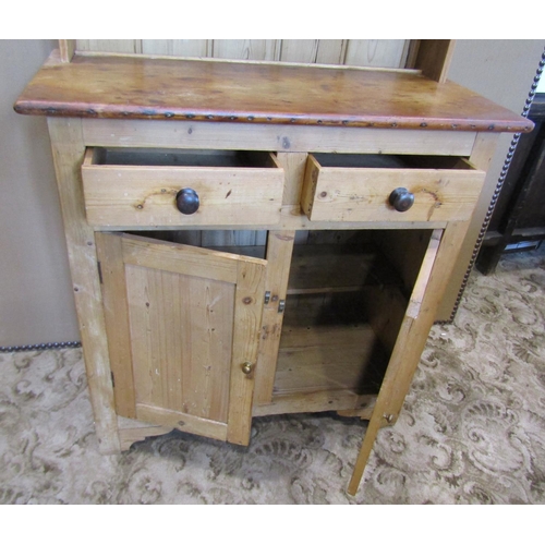 2119 - A stripped pine cottage kitchen dresser, the base enclosed by a pair of rectangular panelled doors b... 