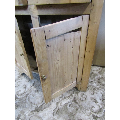 2119 - A stripped pine cottage kitchen dresser, the base enclosed by a pair of rectangular panelled doors b... 