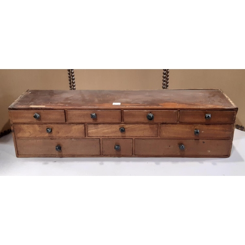 2163 - A vintage/nest of ten mahogany and stain pine drawers 88 cm wide x 24 cm deep x 22 cm high