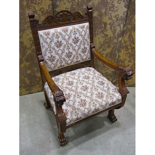 2168 - A Victorian carved oak open armchair with lions mask and foliate detail, upholstered seat and back r... 