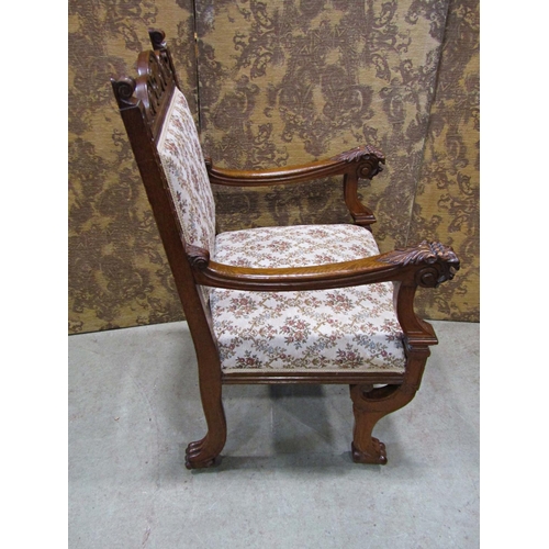 2168 - A Victorian carved oak open armchair with lions mask and foliate detail, upholstered seat and back r... 