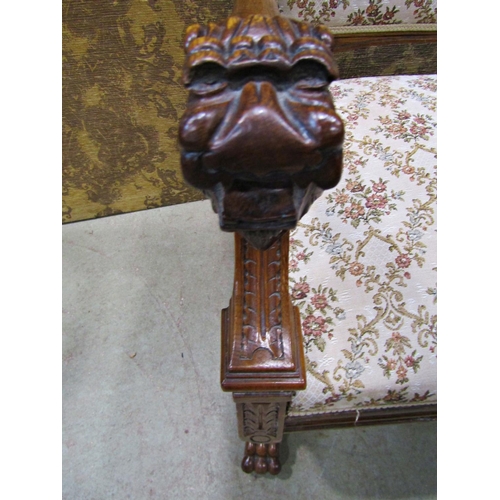 2168 - A Victorian carved oak open armchair with lions mask and foliate detail, upholstered seat and back r... 