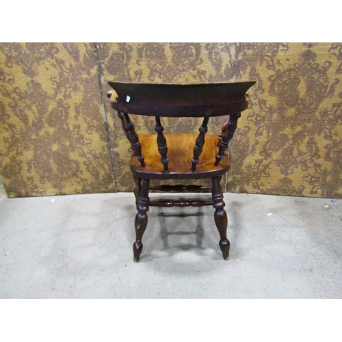 2172 - An antique stained elm and beechwood smokers bow elbow chair with turned spindle back and saddle sha... 