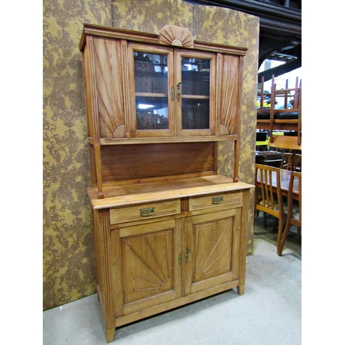 2182 - An early 20th century continental stripped pine kitchen dresser with moulded sunburst detail, the ba... 