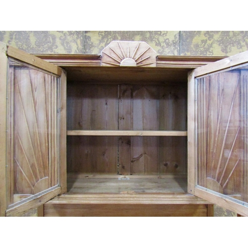 2182 - An early 20th century continental stripped pine kitchen dresser with moulded sunburst detail, the ba... 