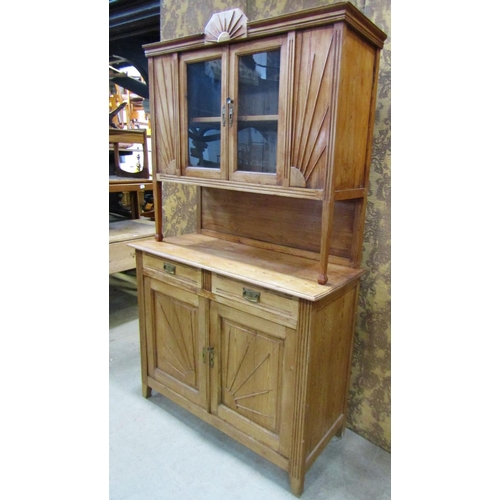 2182 - An early 20th century continental stripped pine kitchen dresser with moulded sunburst detail, the ba... 