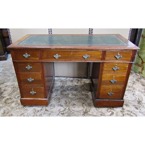 2186 - A late Victorian/Edwardian walnut kneehole twin pedestal writing desk with inset leather top over an... 