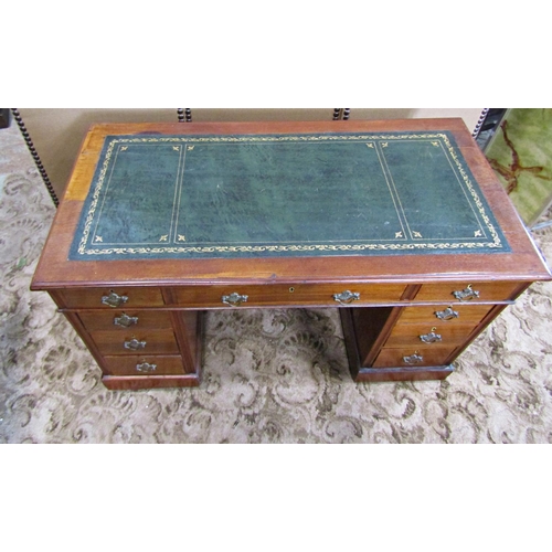 2186 - A late Victorian/Edwardian walnut kneehole twin pedestal writing desk with inset leather top over an... 