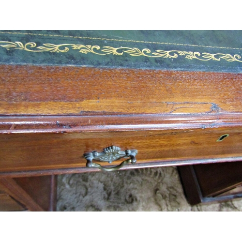 2186 - A late Victorian/Edwardian walnut kneehole twin pedestal writing desk with inset leather top over an... 