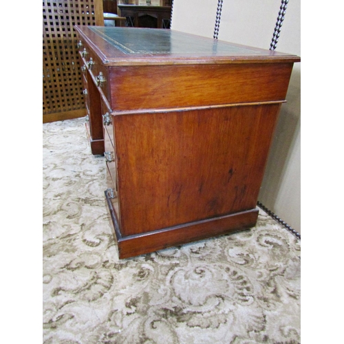 2186 - A late Victorian/Edwardian walnut kneehole twin pedestal writing desk with inset leather top over an... 