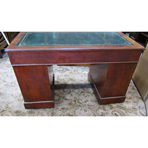 2186 - A late Victorian/Edwardian walnut kneehole twin pedestal writing desk with inset leather top over an... 