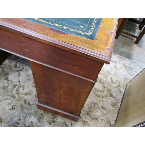 2186 - A late Victorian/Edwardian walnut kneehole twin pedestal writing desk with inset leather top over an... 