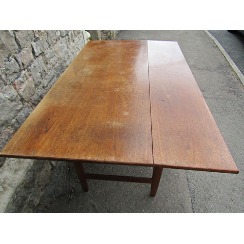 2188 - A mid 20th century teak single drop leaf dining table raised on tapered and moulded legs partially u... 