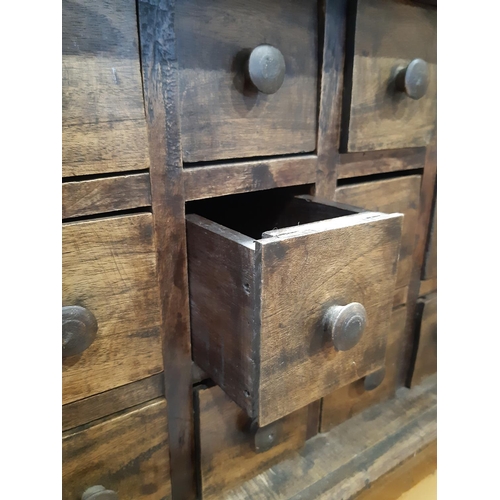 2227 - A hardwood table top nest of 18 small drawers raised on bracket feet, 65cm wide x 31cm deep x 35cm h... 