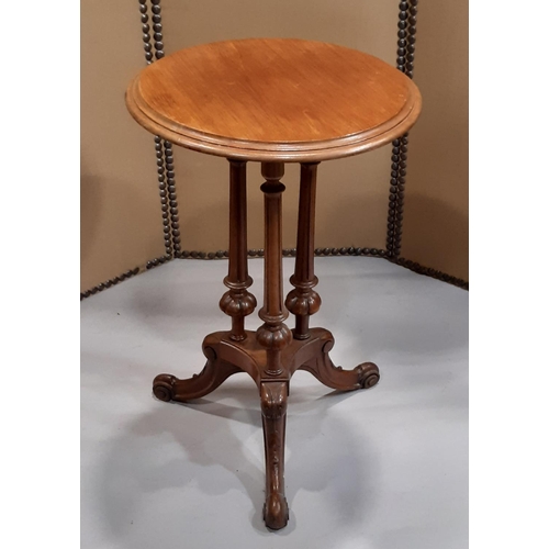 2266 - A Victorian mahogany occasional table the circular top raised on three turned and fluted columns, pl... 