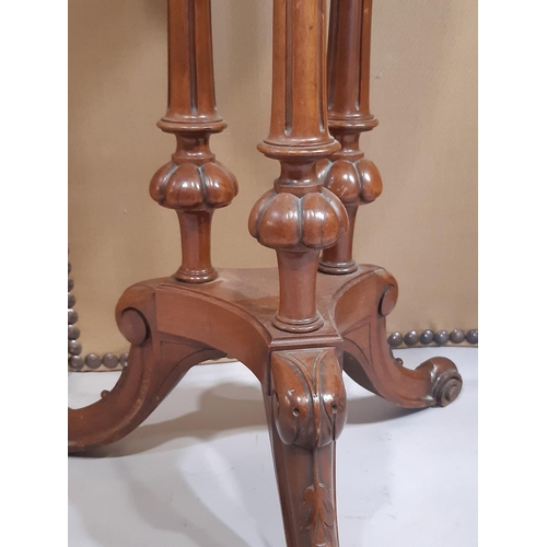 2266 - A Victorian mahogany occasional table the circular top raised on three turned and fluted columns, pl... 