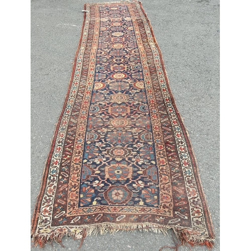 1688 - An old Persian hand knotted runner with an all over stylised floral design, 346 cm x 104 cm approxim... 