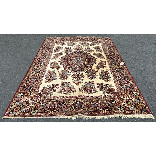 1691 - A Persian design Wilton type machine made carpet with an all over floral pattern on a cream ground  ... 