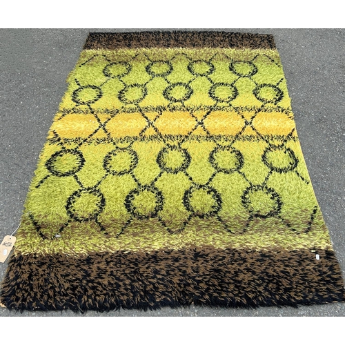 1692 - A retro shag pile carpet with green, yellow and flecked bands on a noughts and crosses pattern 205 c... 